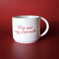 White mug with 'You are my favorite' text on a red 