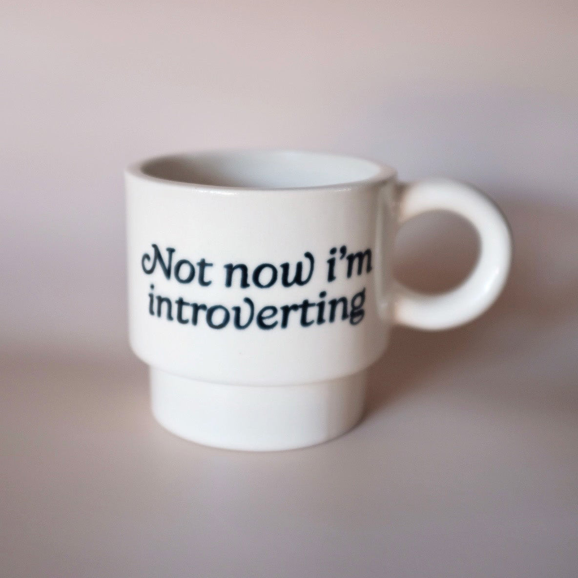 White mug with 'Not now i'm introverting' text 