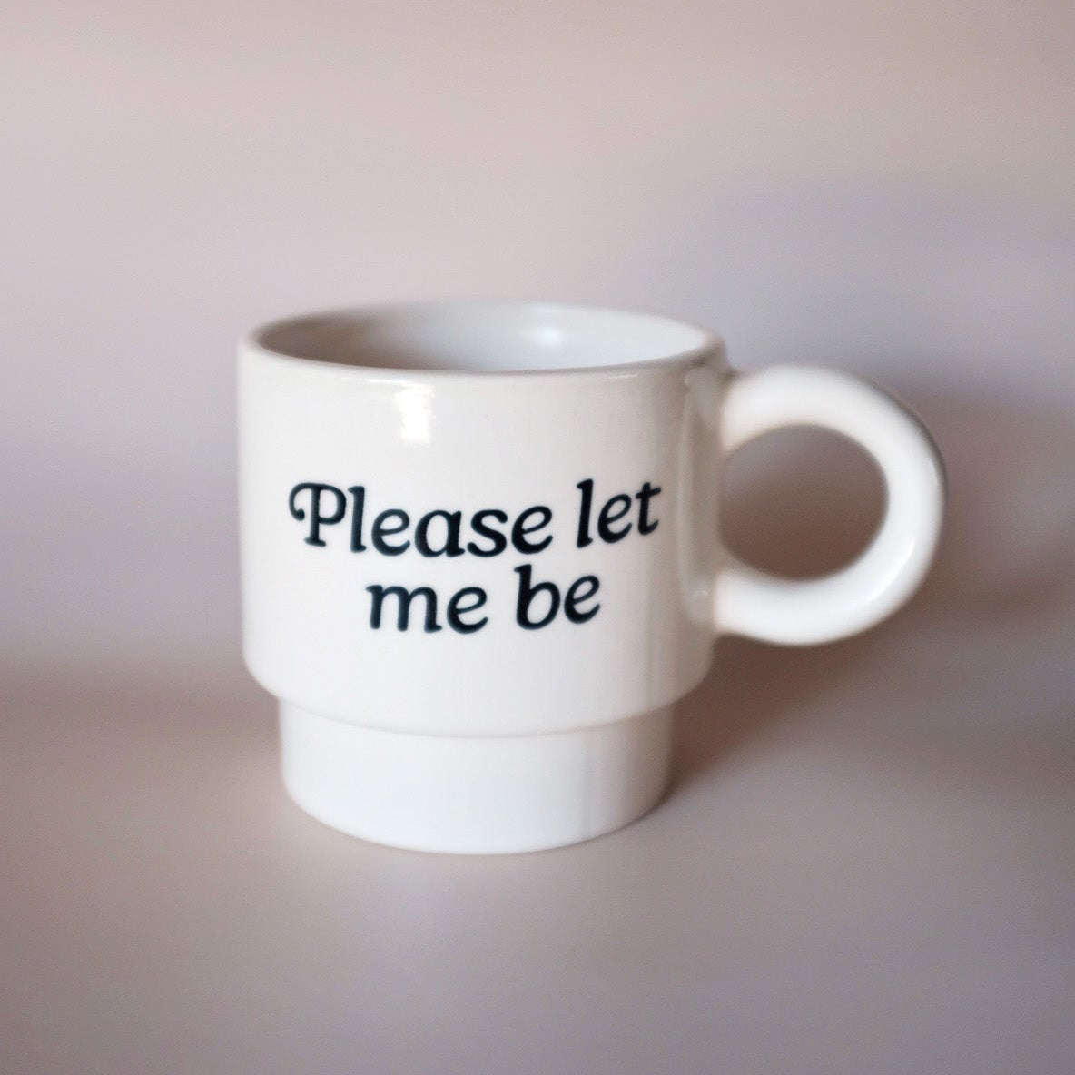 White mug with 'Please let me be' text 